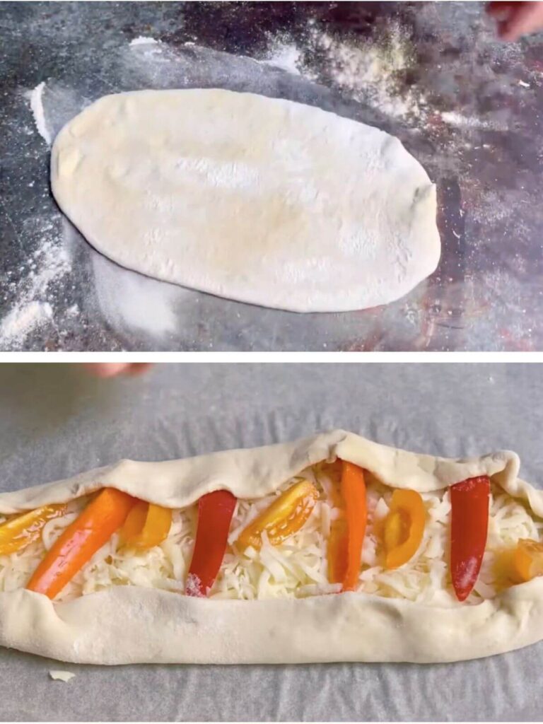 Oval-shaped dough on a floured surface, topped with grated mozzarella, bell pepper, and cherry tomatoes.