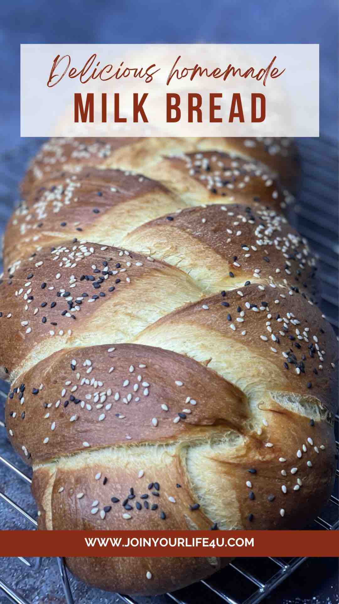 Golden brown 3 Strand Challah Bread topped with black and golden sesame seeds