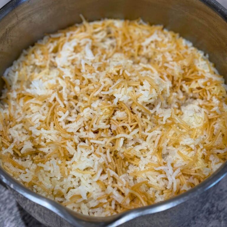 Lebanese rice with vermicelli served in a stainless steel pot.