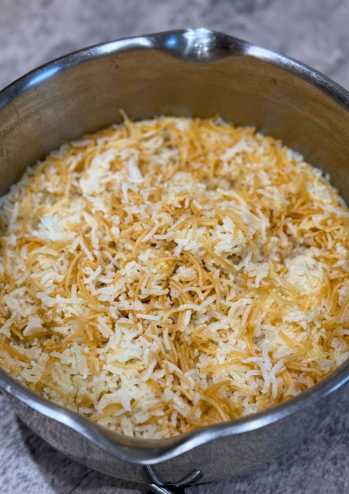 Lebanese rice with vermicelli served in a stainless steel pot.