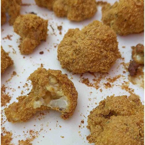 Crunchy Cauliflower Bites with a bite taken out of one.