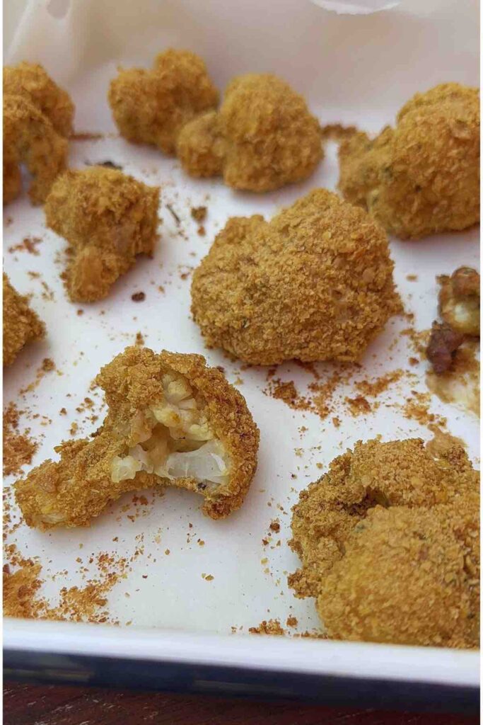 Crunchy Cauliflower Bites with a bite taken out of one.