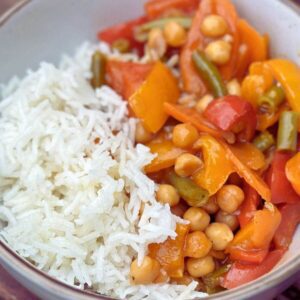 Bowl of Sweet and Sour Vegetable Stir Fry with rice.