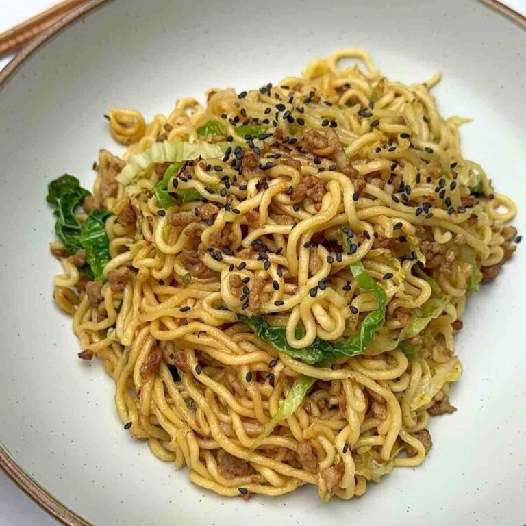 Tantalizing Turkey Mince Noodles on a plate, decorated with black sesame seeds