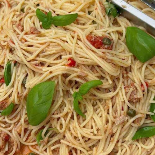 Tuna, caper & chilli spaghetti in a pan ready to be served