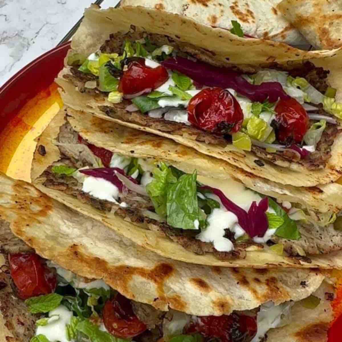 Juicy turkey mince patties seasoned with herbs and Baharat spice, topped with Greek yogurt, pickled cucumber, grilled cherry tomatoes, and more.