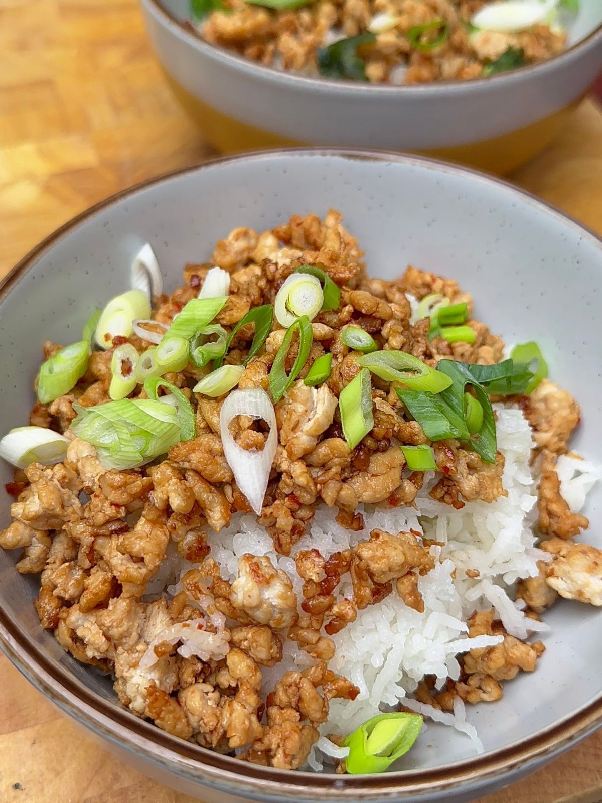 Korean-Style Keema in a bowl over white rice, garnished with fresh green onions.