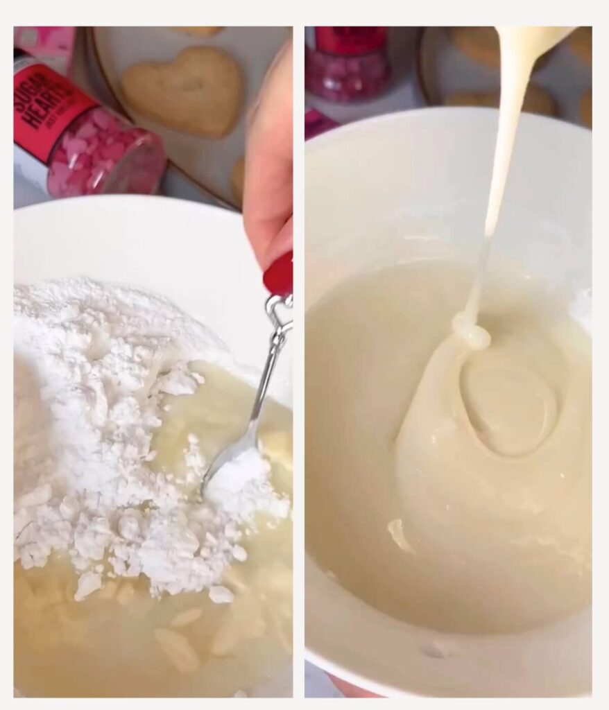 A white bowl filled with icing sugar, milk, and lemon juice being mixed together to create a smooth icing.