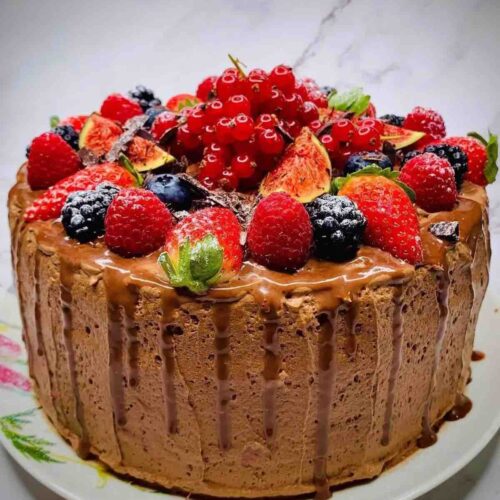 Moist Rich Chocolate Three Layer Berry Mousse Cake decorated with fresh fruits