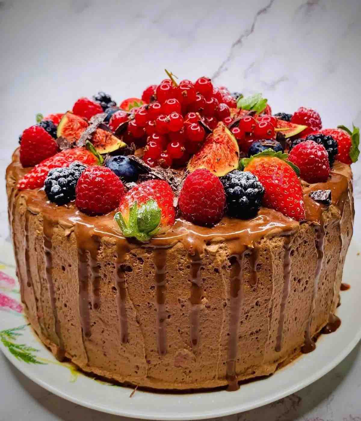 Moist Rich Chocolate Three Layer Berry Mousse Cake decorated with fresh fruits