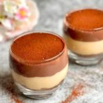 How to make Chocolate and Caramel Pudding in two glasses, one half filled with chocolate pudding and the other half with caramel pudding, topped with cocoa powder