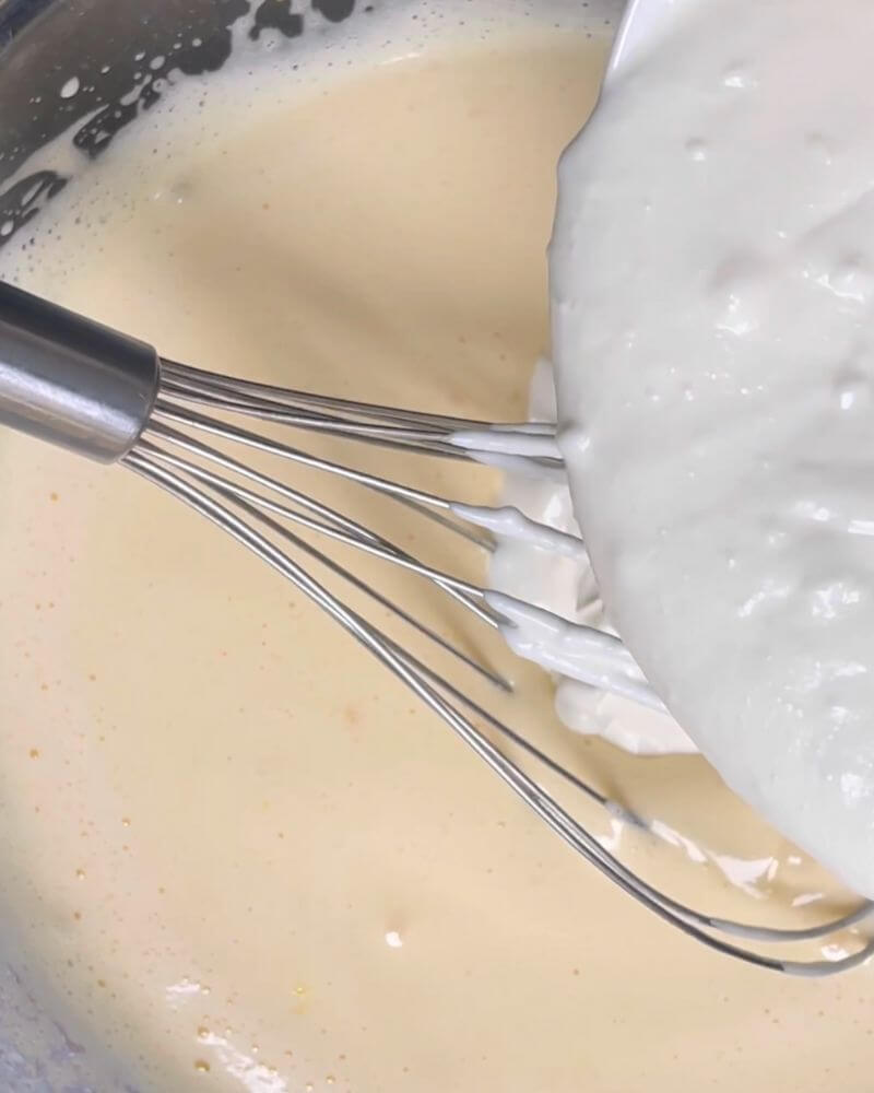 Whisked eggs with sugar, now adding yogurt to the mix. 
