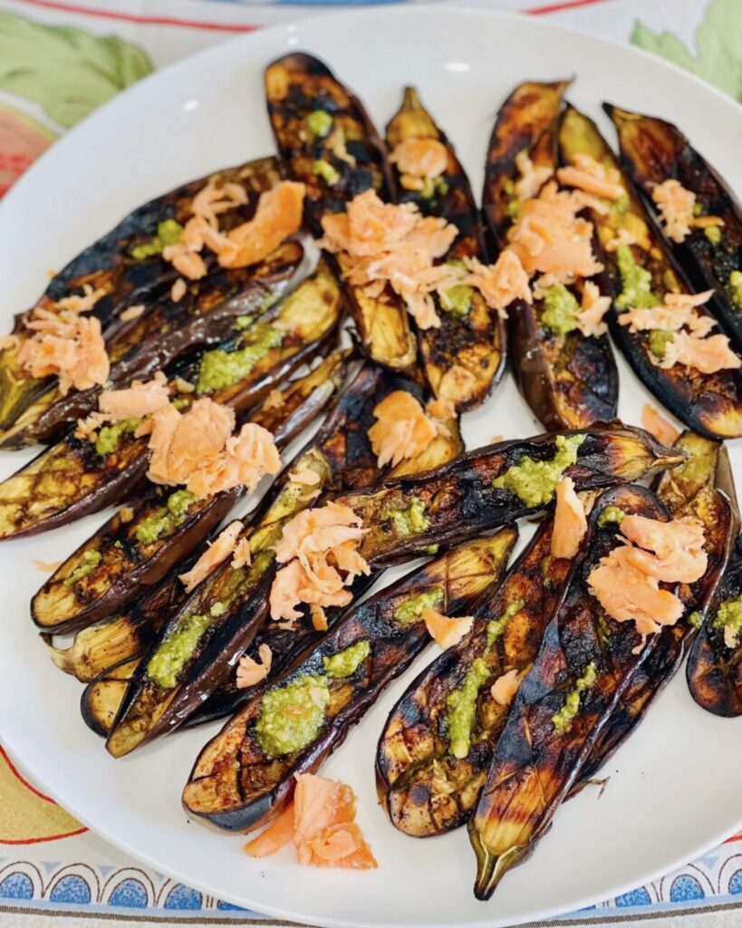 Grilled Eggplants served with pesto and grilled salmon on a plate