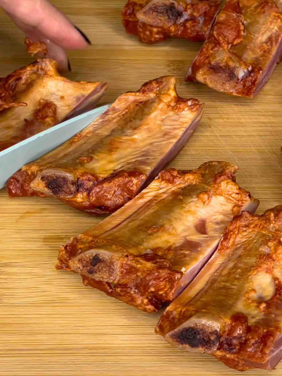 Smoked Ribs cut into small pieces on a wooden board