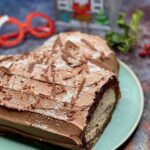 Christmas chocolate Swiss roll on a green dish