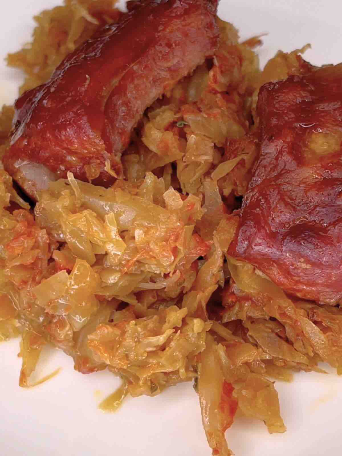 A portion of Pork Ribs and Cabbage Casserole on a white plate