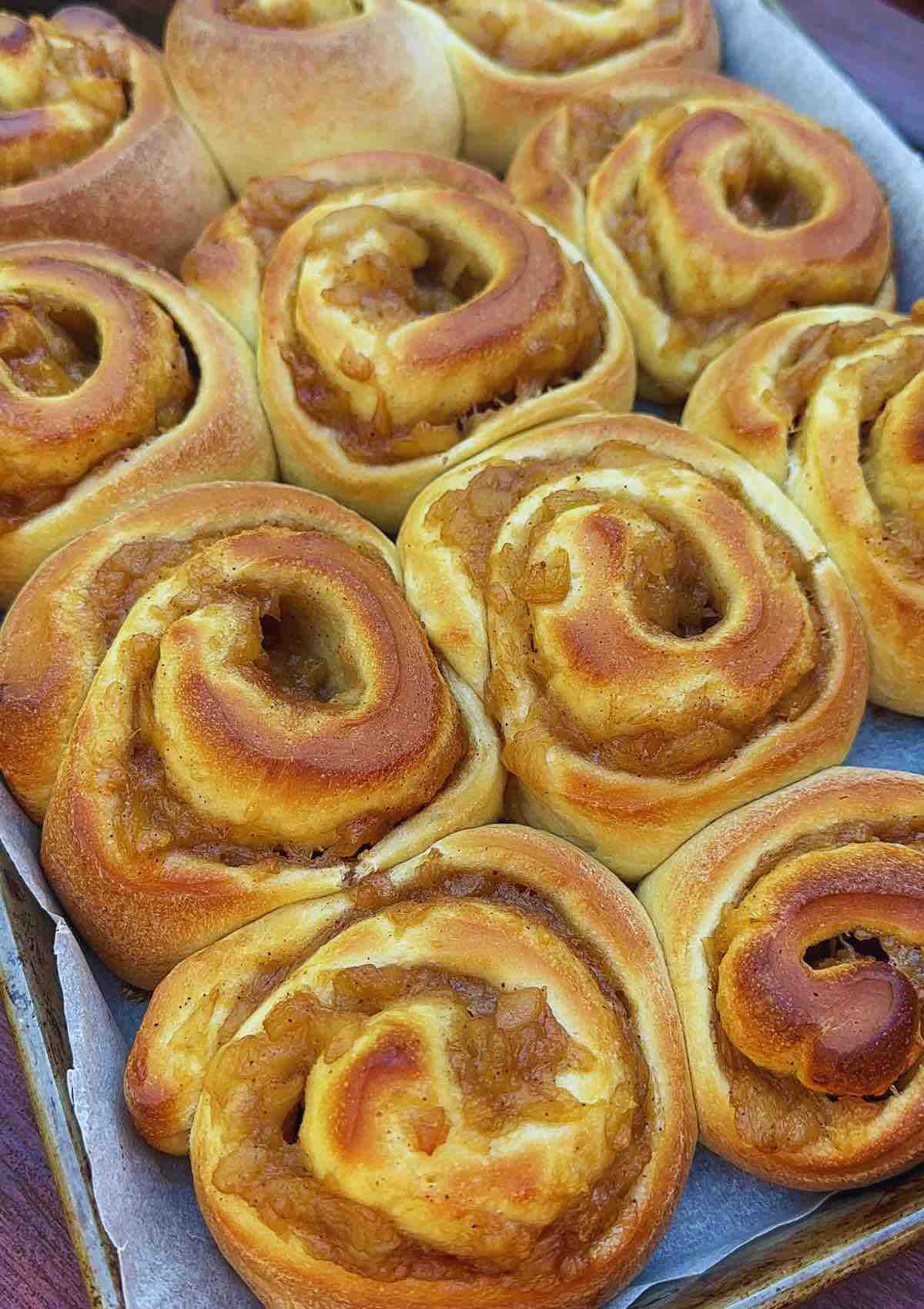 A tray filled with Apple and Cinnamon Rolls just taken out of the oven