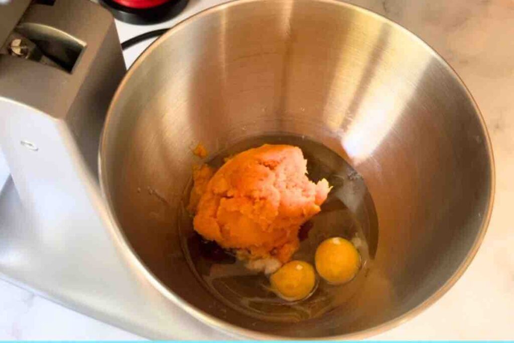 Mixing pumpkin puree, oil, brown sugar, granulated sugar, eggs, and vanilla extract in a bowl until smooth and well combined.