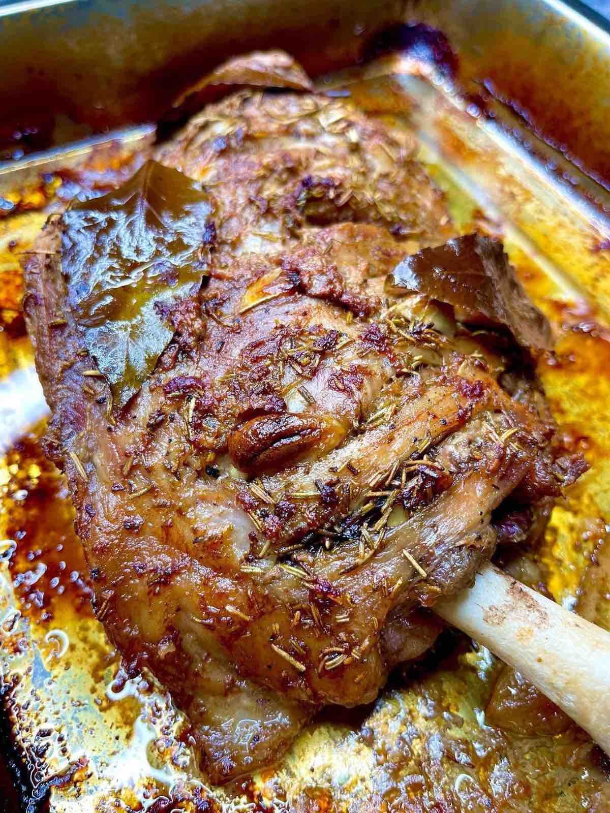 Roast Lamb stuffed with Rosemary and Garlic in a pan 