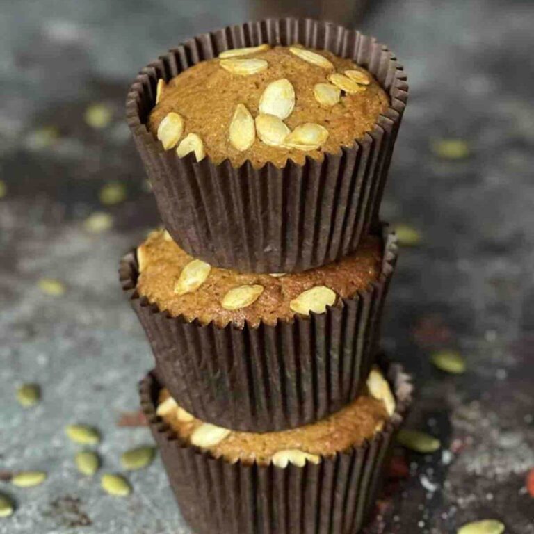 Stack of three pumpkin muffins.