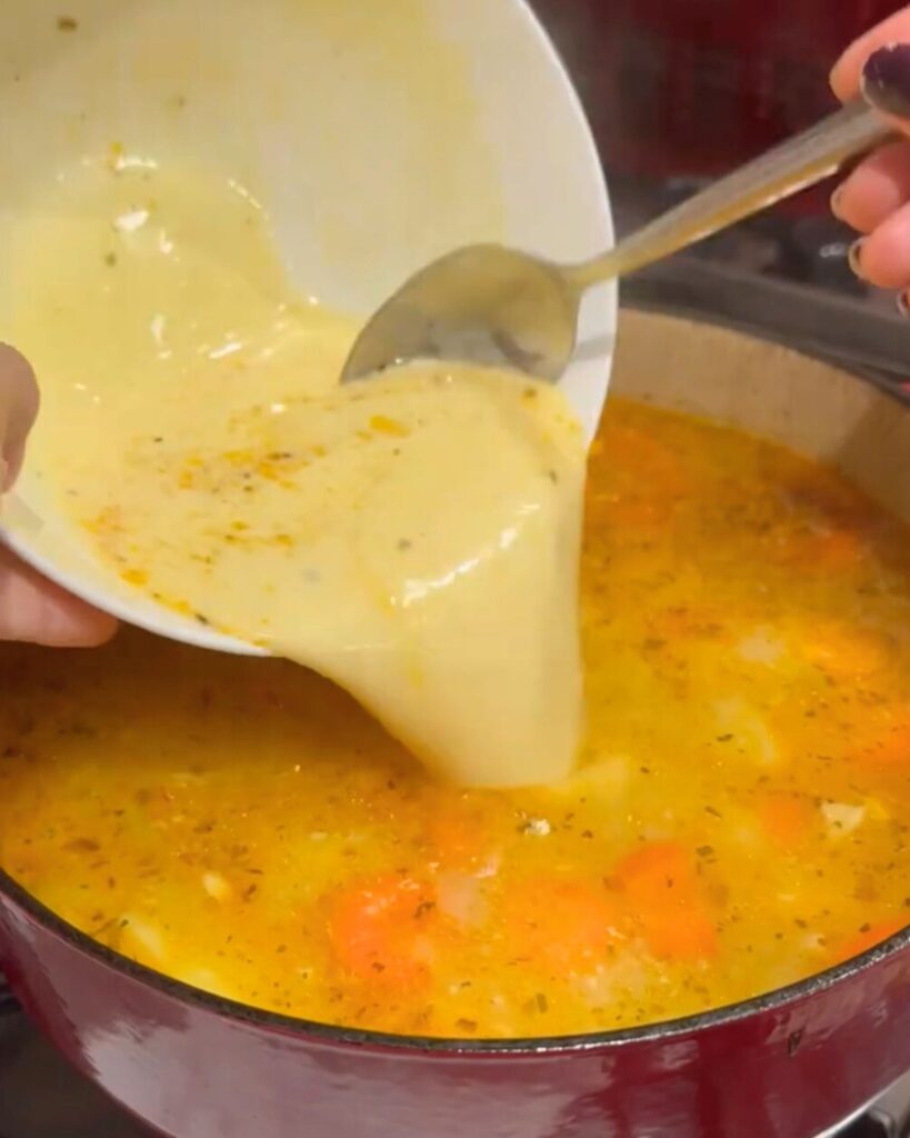 A deep pot with sautéed diced potatoes, carrots, onions, sliced celery sticks and rice, simmering in chicken soup. The "Terbive" egg mix of plain flour, natural yogurt, egg yolk, and lemon juice is now stirred in.