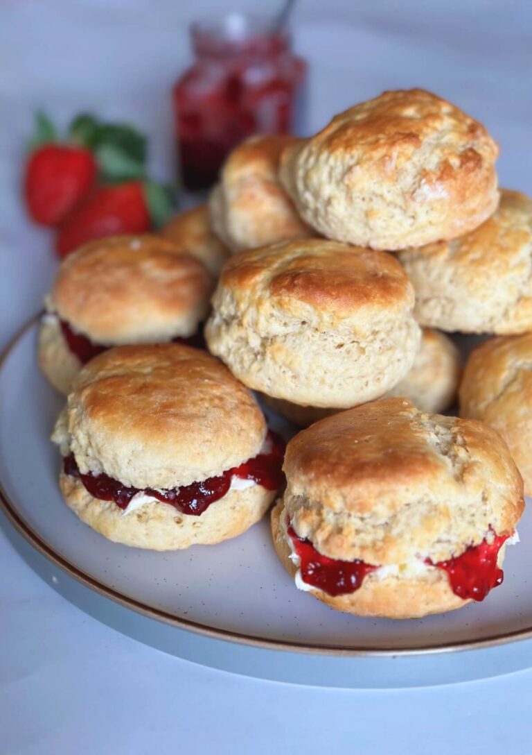 Plate of quick and easy scones with some filled with strawberry jam and others left plain.