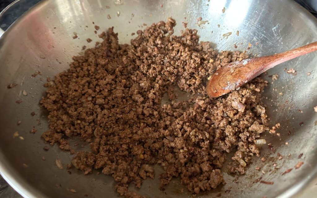 Browned minced beef in a wok.