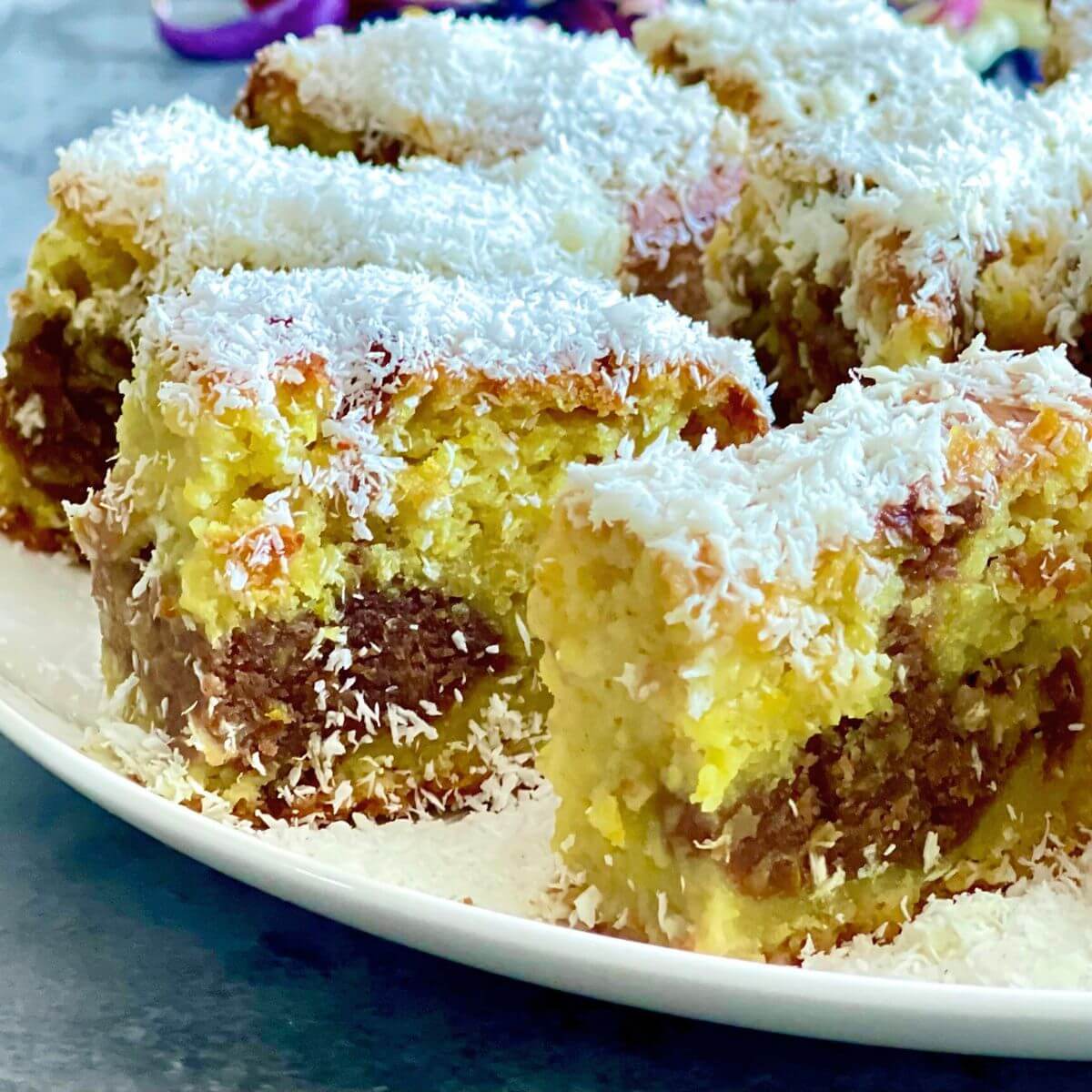 Squares of Orange Coffee Cake arranged on a plate.