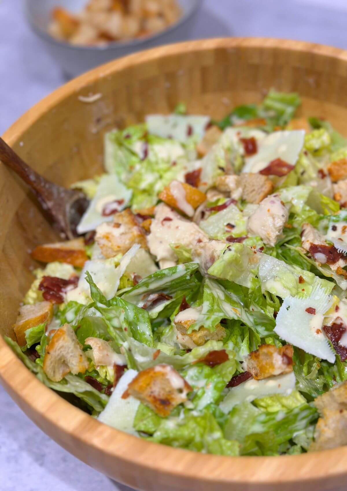 Best Chicken Caesar Salad in a wooden bowl.