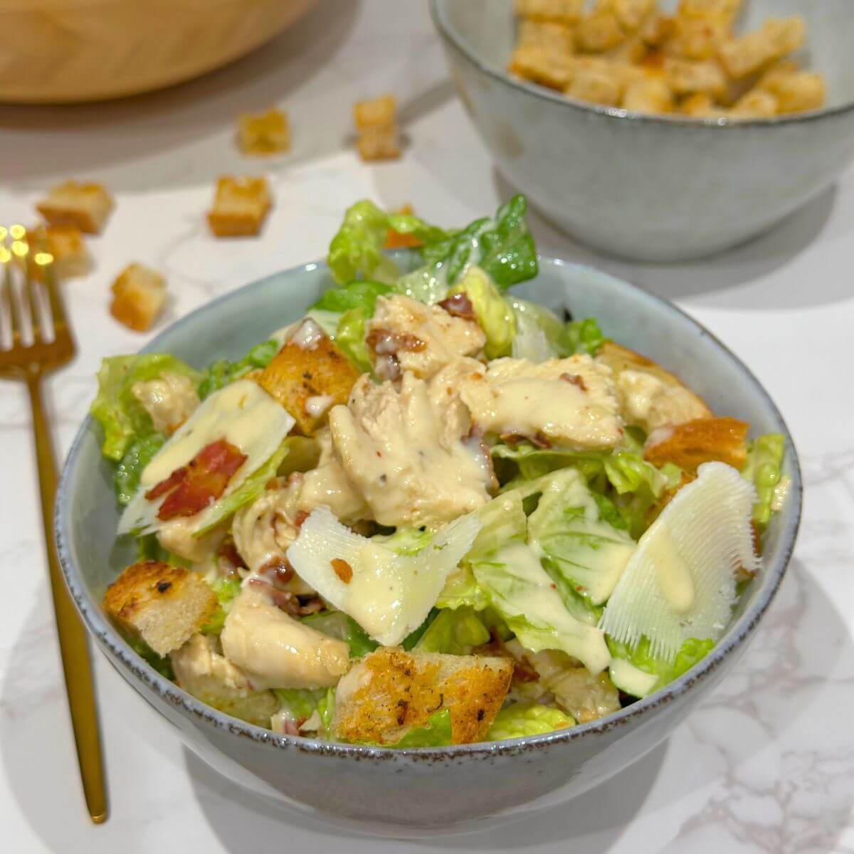 Chicken and Bacon Caesar Salad in a grey bowl. 