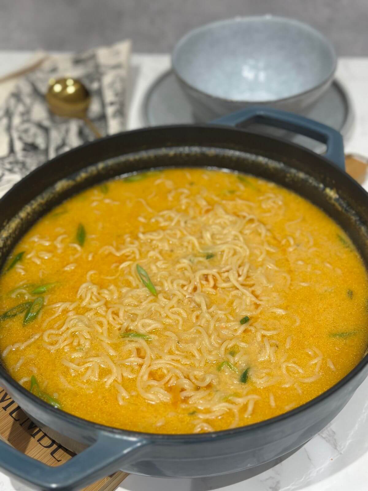 Miso ramen soup into a shallow pot, ready to be served