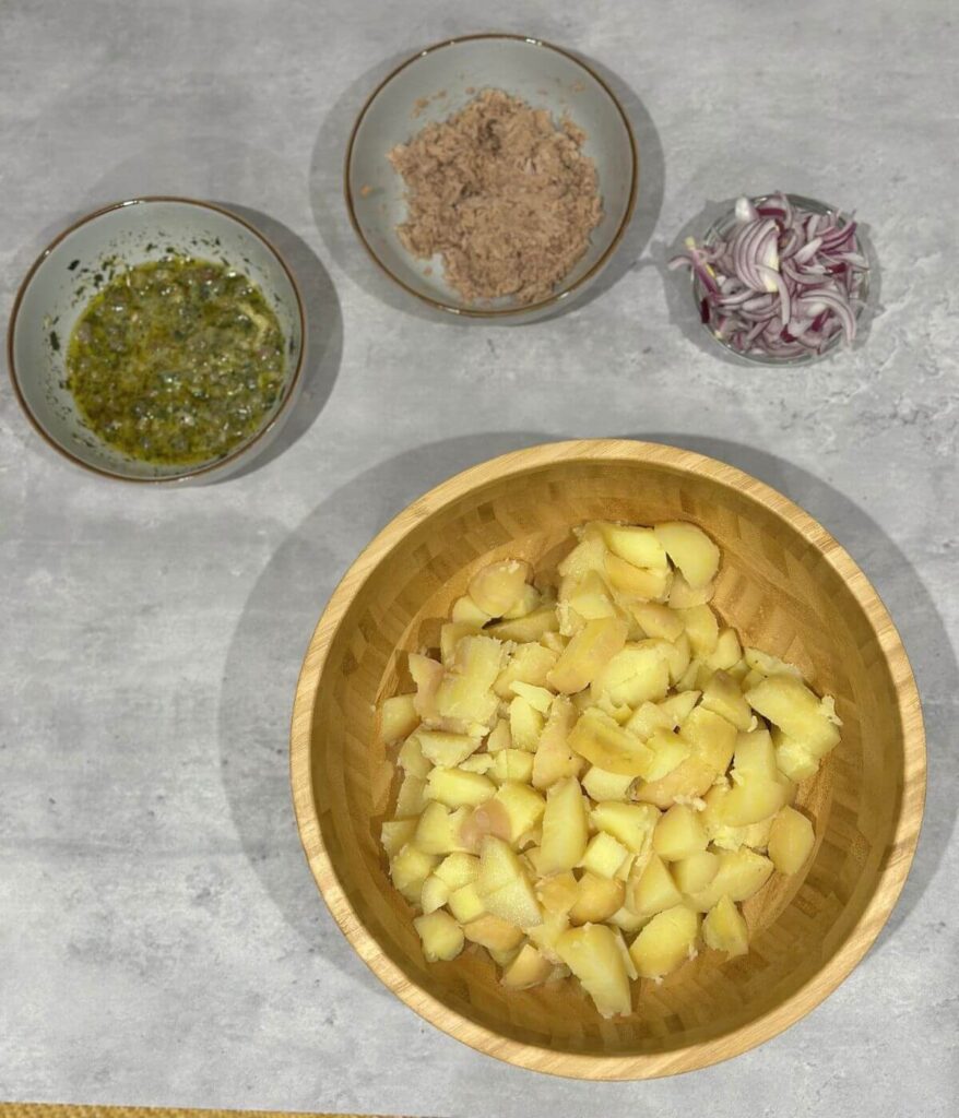 Process shot on how to make tuna and potato salad, all the ingredients laid out