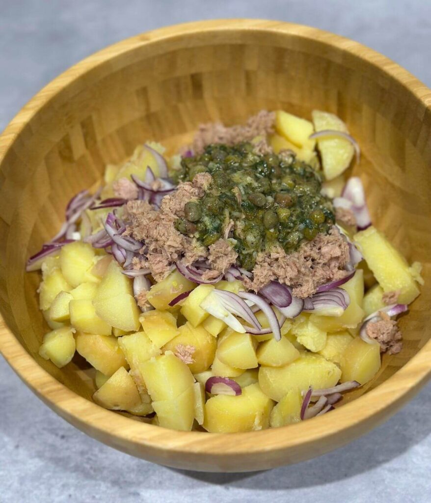 Tuna Potato Salad ingredients in a wooden bowl, ready to mix the ingredients