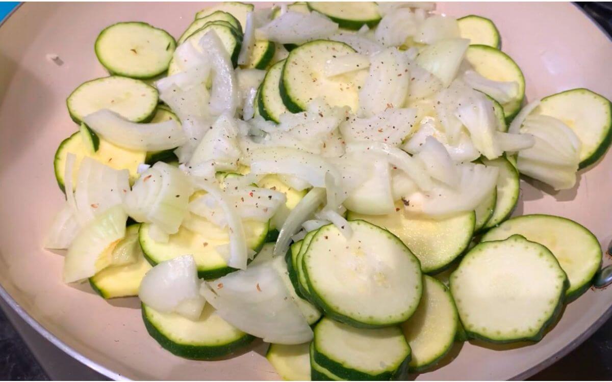 Cooking zucchini and onion in olive oil over medium heat with salt and pepper.