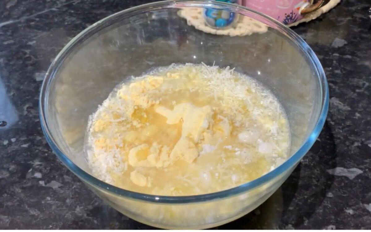 Mixing flour, cornmeal, and seasonings in a large bowl with water and olive oil.